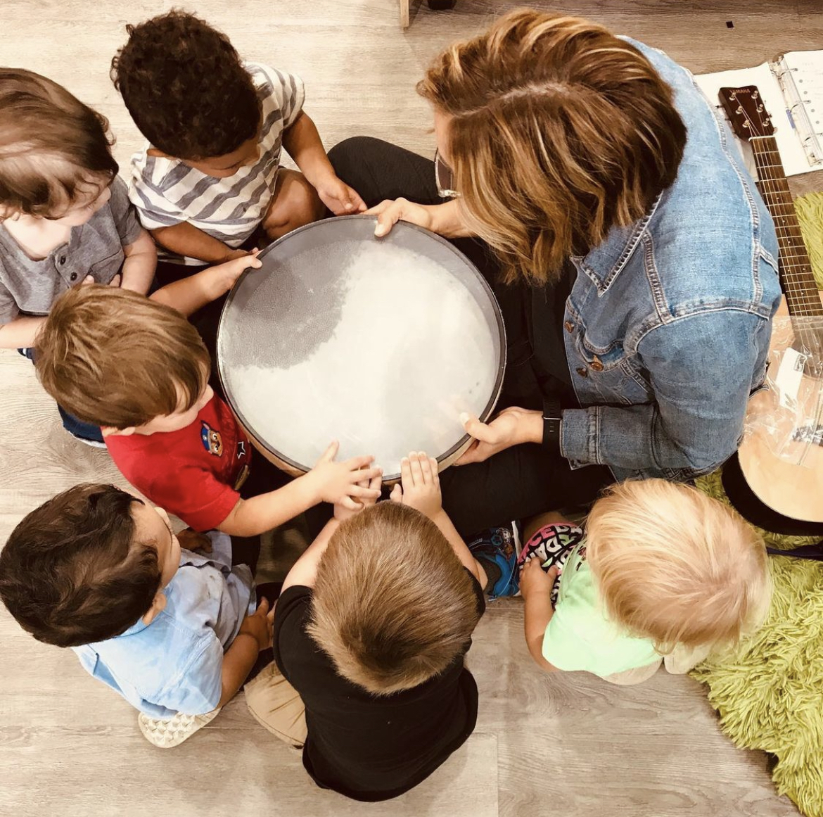 children gather around the ocean drum