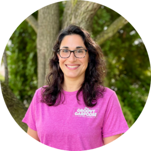 Abbey F Headshot (3) Sarah C stands outside for a headshot in her logo tshirt